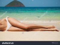 stock-photo-women-s-sexy-legs-on-the-beach-145641190.jpg