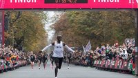 kenyas_eliud_kipchoge_celebrates_as_he_crosses_the_finish_line_at_the_end_of_his_successful_at...jpg