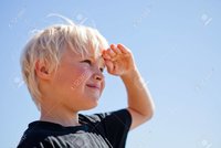 15135417-boy-outdoors-looking-ahead-with-hand-on-forehead.jpg