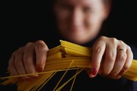 woman-breaking-spaghetti-high-res-stock-photography-523335262-1534447620.jpg