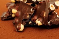 6300905-chocolate-with-nuts-on-the-cocoa-background.jpg