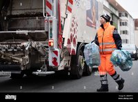 hanover-germany-11th-mar-2020-waste-worker-stefanie-celikdal-throws-garbage-bags-into-a-garbag...jpg