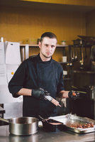 stock-photo-theme-cooking-young-caucasian-man-black-uniform-latex-gloves-restaurant.jpg